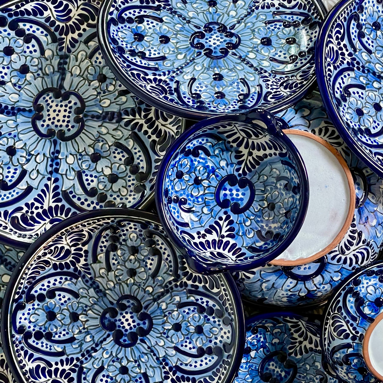 Blue Talavera plates and bowls on top of each other